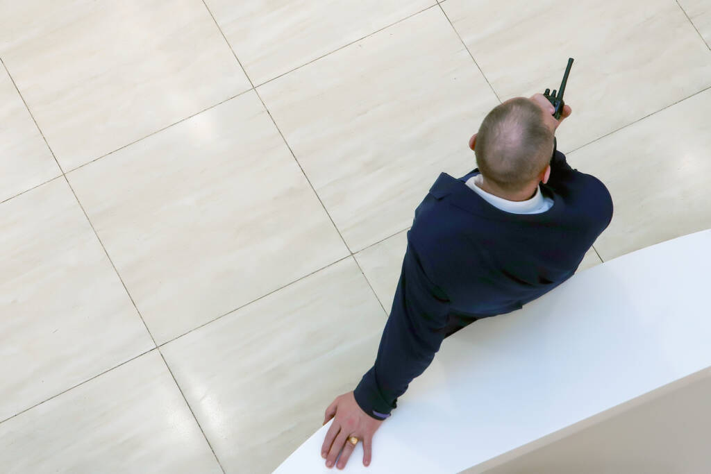 Adult,Male,Security,Guard,In,A,Suit,Talking,On,A