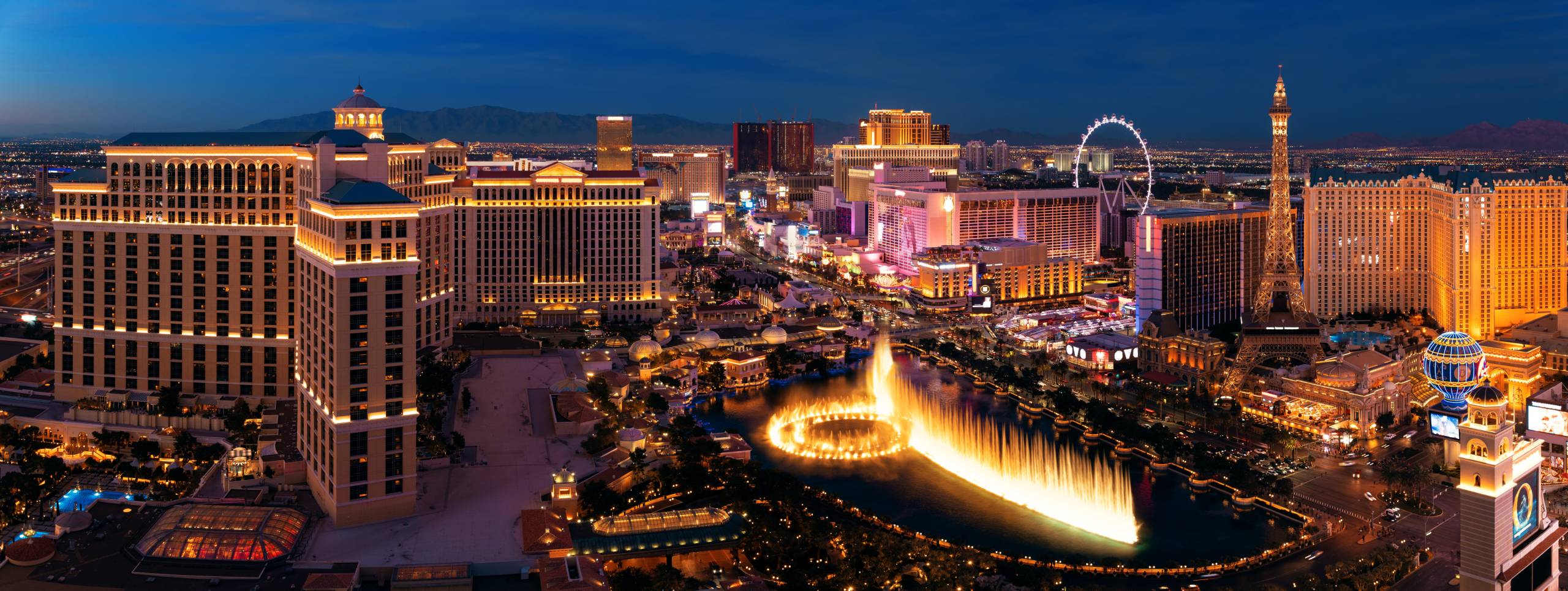 City urban skyline panorama view with modern casino hotel and resort architecture in Strip in Las Vegas at night.